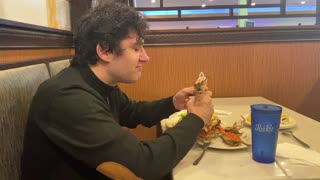 Man eating crab shell in Chinese Buffett