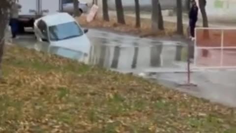 SAMARA SINKHOLE A car has almost been consumed by a sinkhole in Samara,