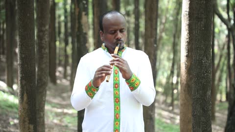 Ethiopian _ man playing cultural Musical instrument " WASHINT"