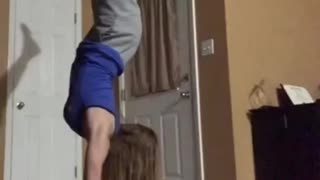 Blue shirt girl does handstand and falls on face