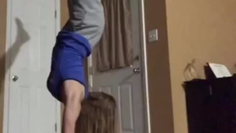 Blue shirt girl does handstand and falls on face