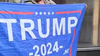 Woman at Trump Tower March 22, 2023 supporting Trump ... reality check.