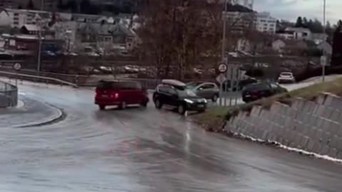 Car Slides Downhill and Narrowly Avoids Collision