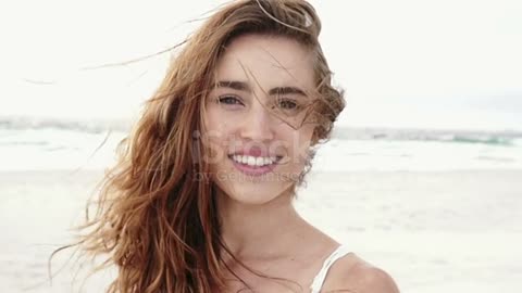 Woman smiling at the beach stock video