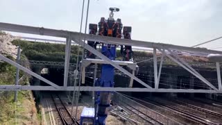 Japan's giant robot helps fix railway wires