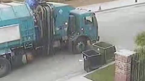 The garbage truck throws away the rubbish