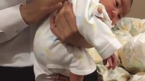 The baby lies on her mother's arm