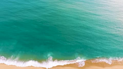DRONE FOOTAGE OF A BEACH BLUE WATER