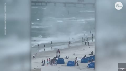 Cameras capture waterspout ripping through crowded beach | USA TODAY