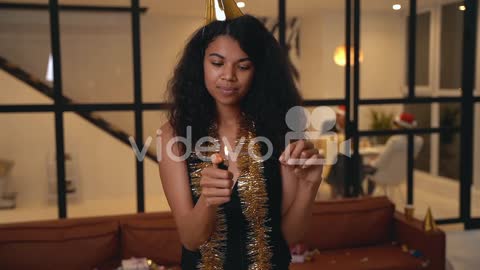 Beautiful Black Woman Lights A Sparkler With A Lighter At New Year's Eve Party