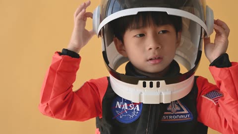 A kid wearing Toy Space Helmet