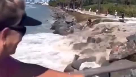 Sneaker Wave knocks down and sweeps several people into the ocean.