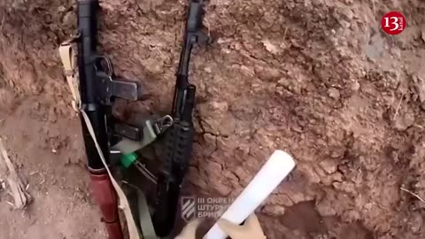 Ukrainian fighters display the killed Russians and the captured weapons near Bakhmut