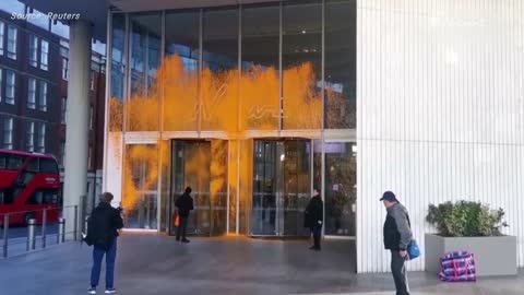 Just Stop Oil supporters paint London buildings orange