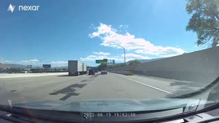 Tire Crosses Barrier and Dodges Traffic to Hit Driver
