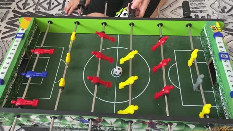 playing a game of football at the foosball table