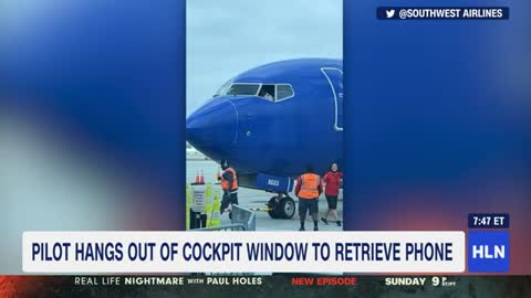 Pilot hangs out of cockpit window to retrieve passenger s phone