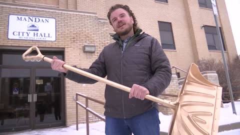 Mandan Business Shoveling Golden Shovel