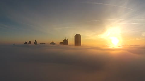 Drone captures Dallas skyline above fog bank
