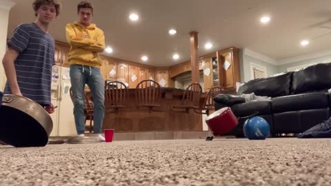 Boy Kicks Ping Pong Ball When Another Boy Almost Completes His Trick Shot