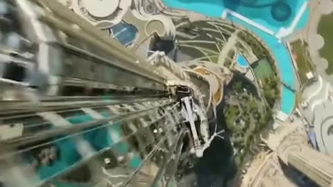 Drone flies from the top of Dubai's Burj Khalifa to the bottom..