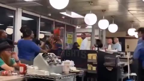 out of control dyed haired individual attacks white Waffle House staffers.