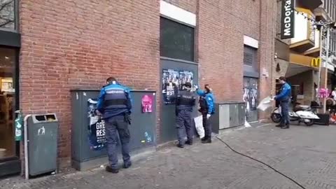 Police in the Netherlands trying to remove great reset posters.