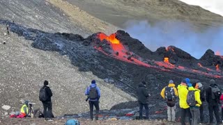 People watch as lava spews out of volcanic fissure in Iceland | AFP