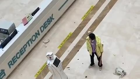Chinese woman smashes up a robot in the hospital.