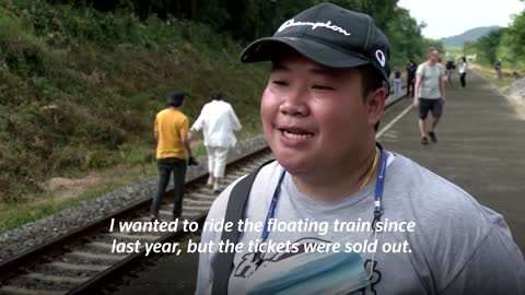 Thailand's 'floating train' a hit as dam waters rise