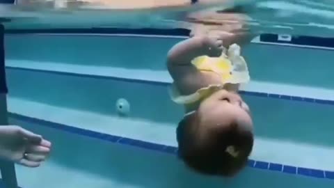 little girl swimming under water