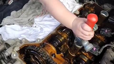 The little mechanic is working hard on the engine.