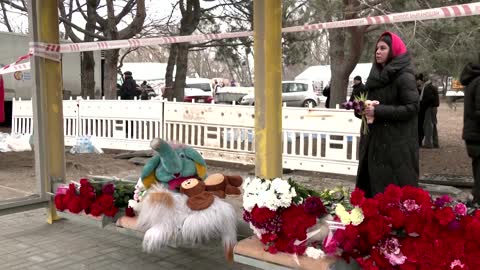 Tearful neighbors lay flowers for Dnipro victims