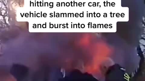 Video shows first responders rescuing a woman trapped undera burning car