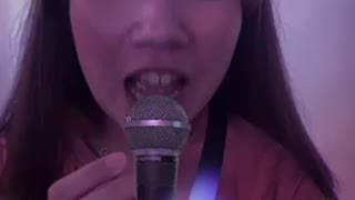 A woman singing in a karaoke room