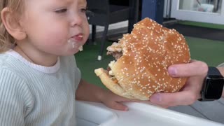 The baby wanted to make this delicious burger, but she got an onion