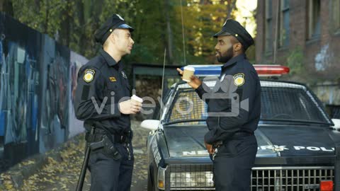 Multiethnic Policemen Resting Outdoors And Sipping Coffee To Go