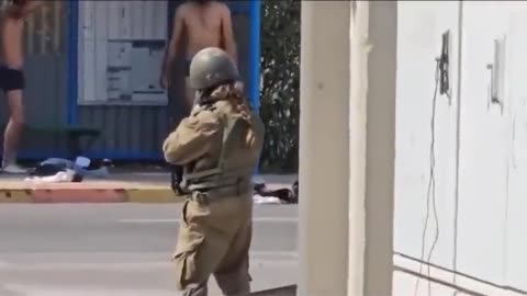A female IDF soldier forces two Hamas terrorists to take off their clothes