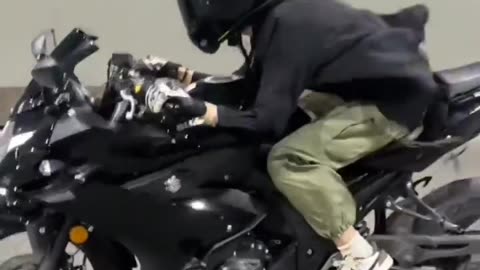 The girl rides a motorcycle very fast