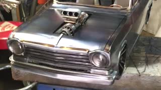 Man Beautifully Crafts Small 3D Metal Car