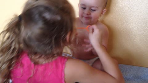 Big sister makes baby brother giggle