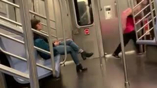 Man in pink dress runs out of subway