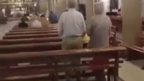 North Africans enter a Catholic mass in Toledo, Spain, filming themselves