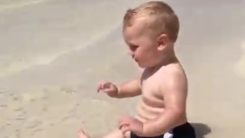 Cute beach baby scared of waves. Short video