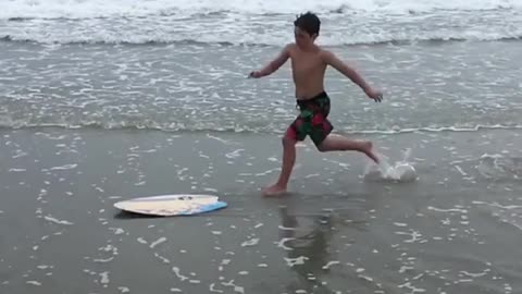 Collab copyright protection - boy yellow skimboard faceplant beach