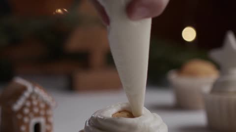 decorating a cupcake with gingerbread cookie