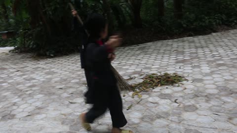 Very cute kids clean up the playground near forest