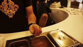 Adorable boy is making so yummy and delicious ice cream in a appetizing manner.