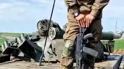 Ukraine War - Russian soldier of Chechen origin on a captured Ukrainian tank