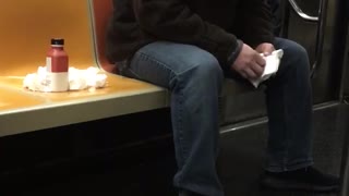 Man whipping nose tissues on subway seat